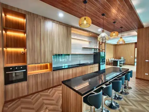 5 Bedroom House for Rent in Mabprachan modern kitchen with wood cabinetry and black marble island