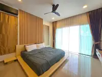 3 Bedroom House for Sale in Mabprachan master bedroom with wooden headboard and bright curtained window