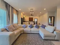 3 Bedroom House for Sale in Mabprachan spacious living room with large sectional sofa and open kitchen view