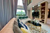 4 Bedroom House for Sale & Rent at Madcha Nirvana bright living room with plush sofa and marble-panel TV wall