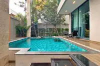 4 Bedroom House for Sale & Rent at Madcha Nirvana outdoor pool area surrounded by greenery and wooden deck