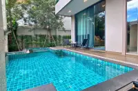 4 Bedroom House for Sale & Rent at Madcha Nirvana turquoise tiled swimming pool with garden view and patio chairs