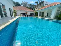 7 Bedroom House for Sale at Majestic Residence Pratumnak poolside view with sun loungers and glass sliding doors