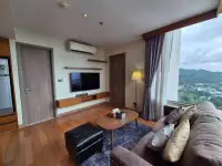 1 Bedroom Condo for Rent at Marina Bayfront Sriracha lounge area with TV, wood floors and mountain view