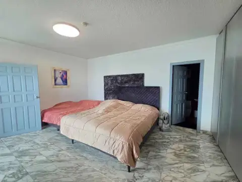 2 Bedroom Condo for Rent at Markland Condominium bedroom with two beds, marble floor and en-suite bathroom entrance
