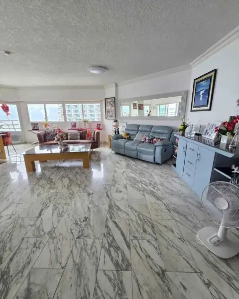 2 Bedroom Condo for Rent at Markland Condominium spacious living area with blue recliner sofa, mirror and marble flooring