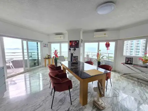 2 Bedroom Condo for Rent at Markland Condominium dining area with marble table, red chairs and balcony access overlooking the sea