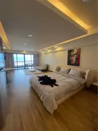 1 Bedroom Condo for Sale at Metro Jomtien Condotel bedroom with ocean view and colorful wall art