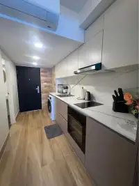 1 Bedroom Condo for Sale at Metro Jomtien Condotel modern kitchen with marble countertop and built-in appliances