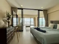 1 Bedroom Condo for Sale at Metro Jomtien Condotel bedroom with ocean-view balcony and dresser