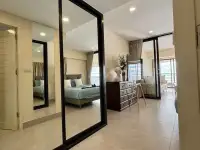 1 Bedroom Condo for Sale at Metro Jomtien Condotel hallway with mirrored closet reflecting bedroom