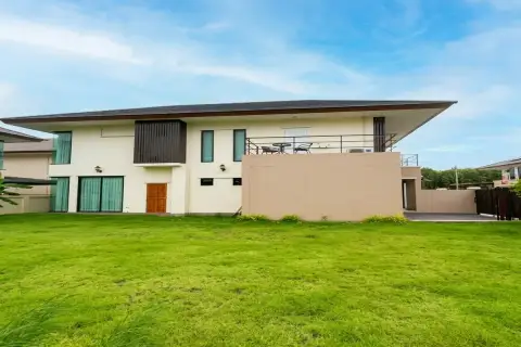 3 Bedroom House for Sale at Villa Asiatic rear exterior view with large green lawn and upper balcony with seating