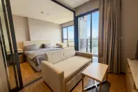 1 Bedroom Condo for Rent at Once Pattaya bedroom with double bed sofa and floor-to-ceiling windows overlooking cityscape