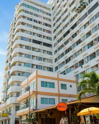 Thian Tong Condotel white high-rise building facade with balconies above street-level shops