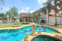 3 Bedroom House for Sale at Mike Orchid Villas 2, swimming pool with decorative statues and a garden with gazebo.