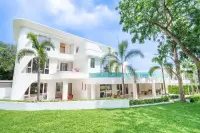 6 Bedroom House for Sale in Huai Yai modern white multi-storey facade with covered terrace and lush green lawn