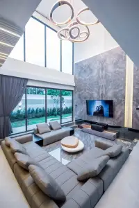 7 Bedroom House for Sale & Rent at Nagawari Pattaya double-height living room with marble wall and sectional sofa