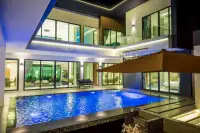 7 Bedroom House for Sale & Rent at Nagawari Pattaya illuminated pool and waterfall feature at night