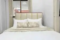 3 Bedroom House for Sale in Na Kluea bedroom with upholstered headboard, white bedding, and window view of rooftops