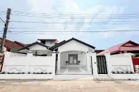 3 Bedroom House for Sale in Na Kluea white exterior facade with covered carport and gated entrance