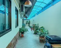 3 Bedroom House for Sale in Na Kluea covered side walkway with potted plants and outdoor grill