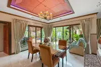 3 Bedroom House for Sale in Na Kluea dining area with marble floors, chandelier and garden view