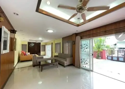 5 Bedroom House for Rent in Na Kluea spacious living area with sofas and sliding doors to patio