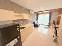 2 Bedroom Condo for Sale at Natureza Art kitchen with mosaic backsplash, fridge, and living room view
