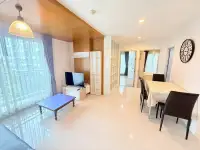 2 Bedroom Condo for Sale at Natureza Art open living and dining area with wall clock and tiled flooring