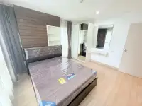 2 Bedroom Condo for Sale at Natureza Art bedroom with wood paneling, mirrored closet, and vanity desk