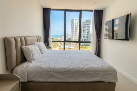 1 Bedroom Condo for Sale at Jewel Pratumnak bedroom with wall-mounted TV and city skyline view