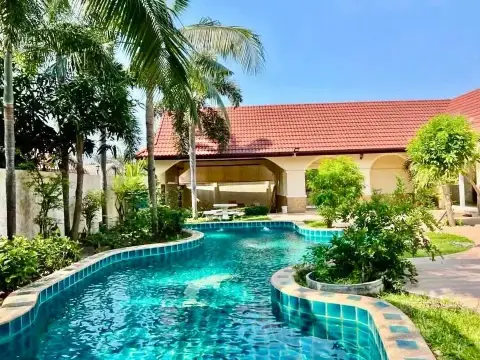 4 Bedroom House for Rent at Nirvana Pool Villa 1 curved pool with tropical garden and covered patio area
