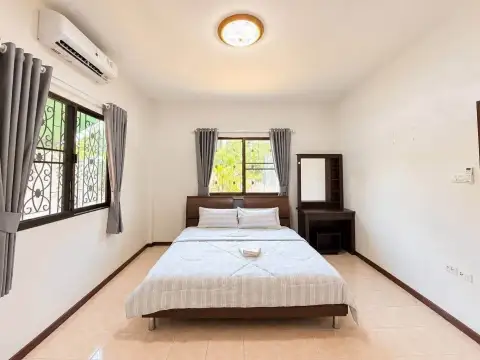 2 Bedroom House for Rent at Noen Plub Wan Village bedroom with double bed and garden view windows