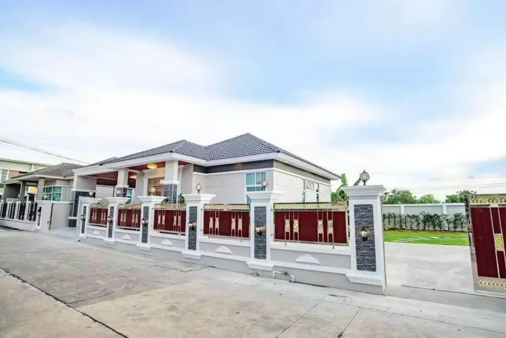 3 Bedroom House for Sale & Rent in Nong Pla Lai exterior view with decorative gated perimeter wall and driveway