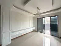 4 Bedroom House for Sale in Nong Pla Lai living room with built-in white cabinetry and crystal chandelier