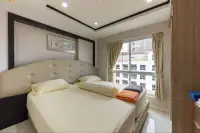 2 Bedroom Condo for Sale at Nordic Residence bright bedroom with tufted headboard and city view window