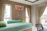 2 Bedroom Condo for Sale at Nordic Residence second bedroom with green bedding and balcony doors