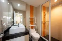 2 Bedroom Condo for Sale at Nordic Residence bathroom with glass shower, black countertop sink, and toilet