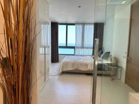 2 Bedroom Condo for Rent at Northpoint bedroom with ocean view seen through glass sliding doors