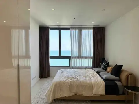 2 Bedroom Condo for Rent at Northpoint master bedroom with sea view and sheer curtains