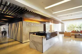 Northshore Pattaya modern fitness center with various weight training machines, benches, and mirrors.