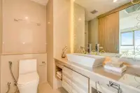 1 Bedroom Condo for Sale at The Riviera Jomtien modern bathroom with vanity, vessel sink, and toilet.
