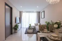 2 Bedroom Condo for Sale at Copacabana Coral Reef bright living and dining area with marble floor tiles and crystal chandelier
