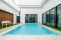 3 Bedroom House for Sale & Rent at PCK Villa private pool with marble surround, white bench, wood slat feature wall and glass sliding doors