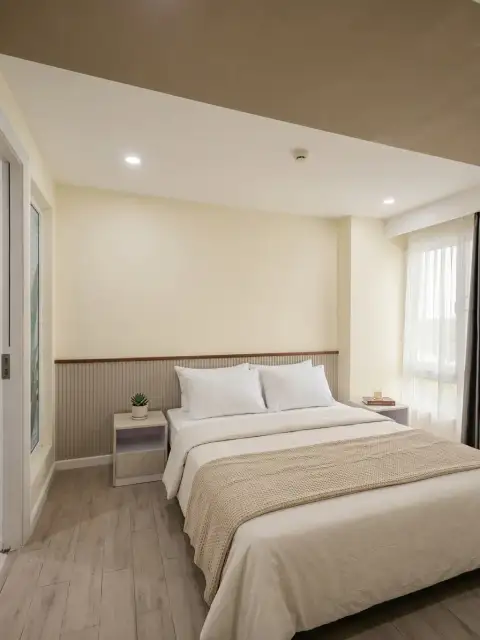 1 Bedroom Condo for Sale at Seven Seas Condo Resort bedroom with queen bed, nightstands and bright window
