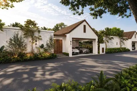 Mirama Pattaya house exterior with double garage, white barn-style facade, and lush tropical landscaping