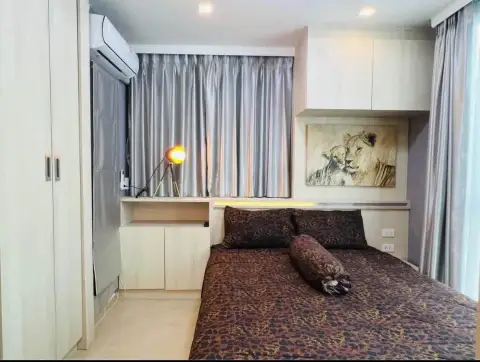2 Bedroom Condo for Rent at Olympus City Garden bedroom with leopard print bedding and lion wall art