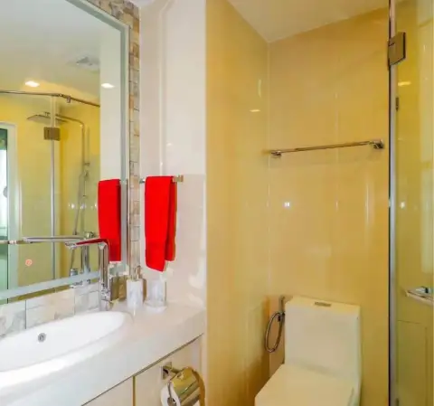 2 Bedroom Condo for Rent at Olympus City Garden bathroom with glass shower, toilet and red towels