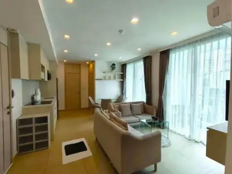 2 Bedroom Condo for Rent at Olympus City Garden bright living room with sofas and floor-to-ceiling curtains