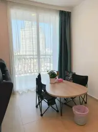 2 Bedroom Condo for Sale at Olympus City Garden dining nook with round table, folding chairs and city view balcony